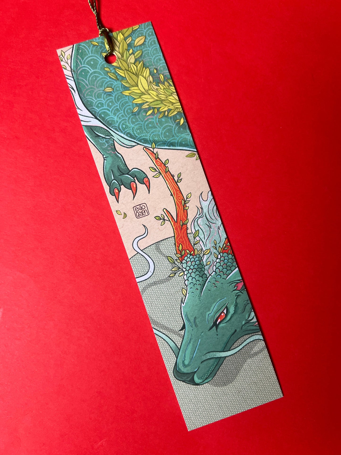 Decorative bookmark with a dragon design on a red background